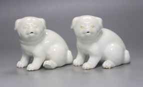 Two Japanese Hirado models of seated puppies, 19th century, 11cm tall