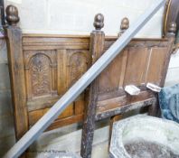 A pair of late 19th century panelled oak single bedsteads with floral carving, width 108cm, height