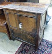 A 17th century oak low cupboard of rectangular form,fitted two cupboards, the upper door off