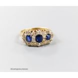 A late Victorian yellow metal, sapphire and diamond set triple cluster ring, with shank