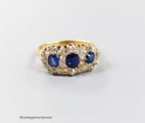 A late Victorian yellow metal, sapphire and diamond set triple cluster ring, with shank