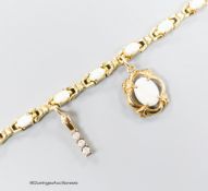 A modern 585 yellow metal and oval white opal set bracelet, hung with two yellow metal charms (