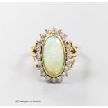 An 18ct, white opal and diamond set oval cluster ring, size N, gross 6.2 grams.