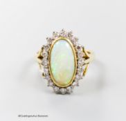 An 18ct, white opal and diamond set oval cluster ring, size N, gross 6.2 grams.