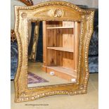 A gilt composition wall mirror in 18th century style,having rectangular plate and shaped decorative