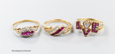 Three modern 9ct gold, ruby and diamond set dress rings including a 'Love' ring, size O, gross