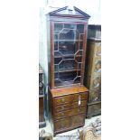 An early 20th century George III style narrow mahogany bookcase on chest, width 65cm, depth 44cm,