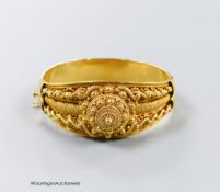A 20th century Victorian style yellow metal (stamped 19k) cannetile work hinged bracelet, interior