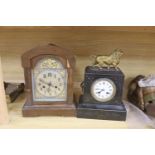 A slate mantel clock with lion surmount and a mahogany mantel clock