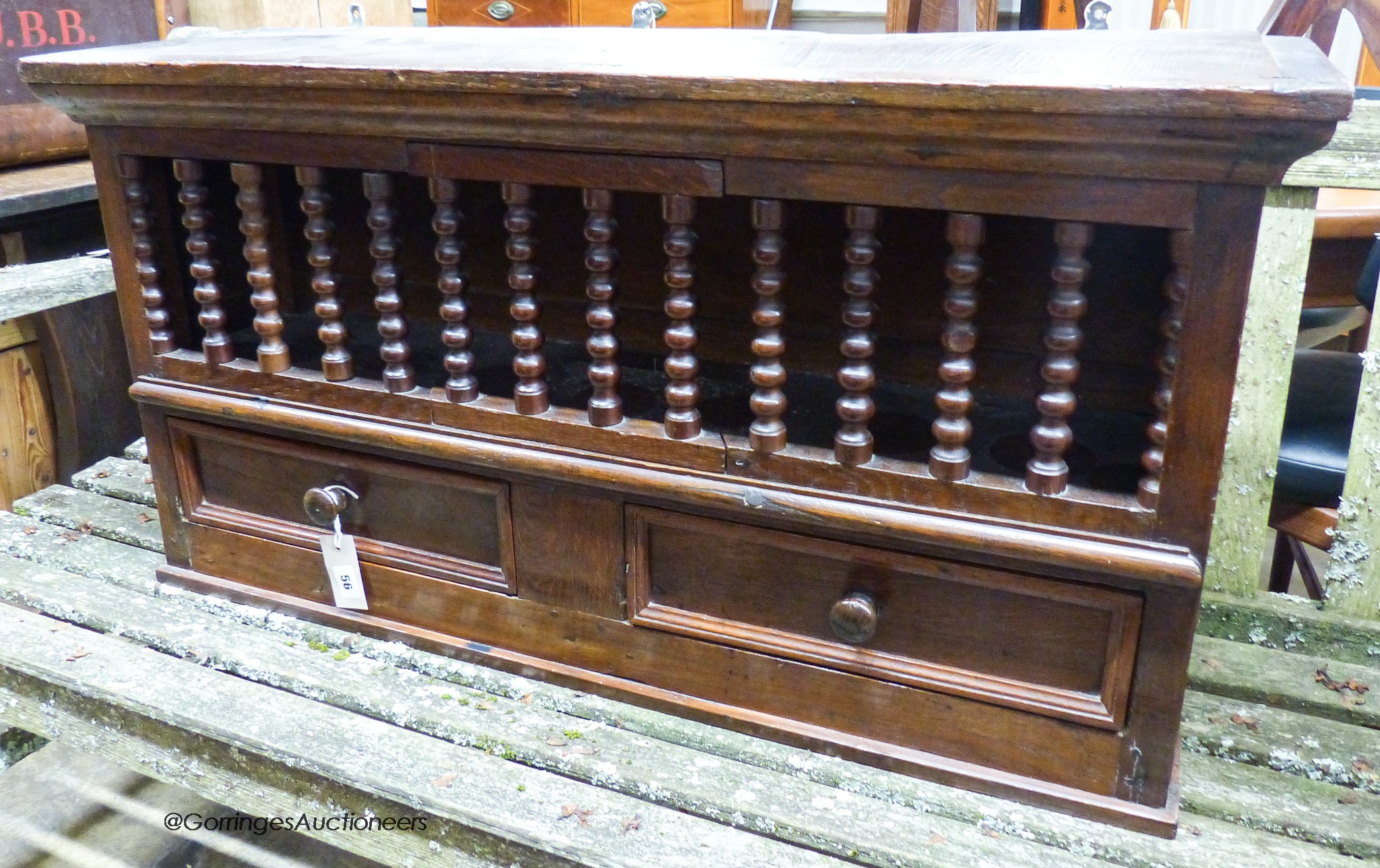 An 18th century and later oak, beech and walnut hanging food cupboard,having spindle front with