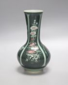A green Japanese artisan studio vase decorated with flower designs, 20cm tall