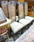 A set of eight William and Mary style walnut dining chairs,with scroll carving, caned backs and