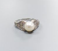 A modern 750 white metal and single stone cultured pearl dress ring, with diamond chip set pierced