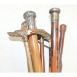 Three silver mounted canes, carved crops and tipstaffs