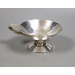 An Arts & Crafts planished white metal single handled pedestal cup, diameter 13.5cm, 6.5oz.