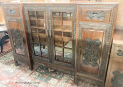 A Chinese carved hardwood breakfront display cabinet, glazed door, length 152cm, depth 33cm, height