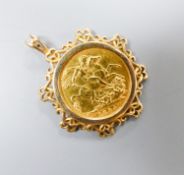 An 1894 gold sovereign in fancy yellow metal mount, overall 39mm, gross weight 12 grams.