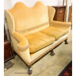 A William and Mary style upholstered wingback settee, length 165cm, depth 75cm, height 121cm