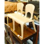 A pair of ‘Comunity’ ergonomic design children’s chairs, 55cm high max.