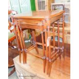 A nest of three Edwardian style inlaid mahogany serpentine tea tables, width 55cm, depth 35cm,