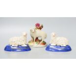 A pair of Staffordshire pottery figures of recumbent sheep, and a similar spell vase, tallest 12.5