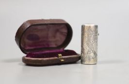 A cased late Victorian silver cylindrical scent bottle, with engraved initials and aesthetic