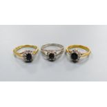 Three modern sapphire and diamond set oval cluster rings, including 18ct white gold, size M and