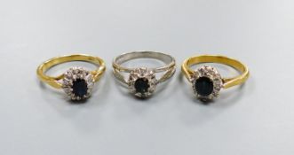 Three modern sapphire and diamond set oval cluster rings, including 18ct white gold, size M and