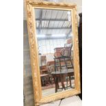 A rectangular carved giltwood framed wall mirror, width 67cm, height 132cm