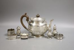 A late Victorian silver teapot, of circular half-fluted pedestal form, London 1899, Edward