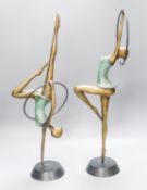 A pair of Hagenauer style bronze figures of hoop dancers, 51.5cm high