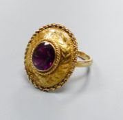 A 19th century engraved yellow metal and garnet set oval dress ring, with rope twist border (ring