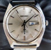 A gentleman's 1980's stainless steel Seiko Lord Matic day date wrist watch, on associated strap,