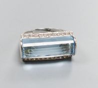 A modern 18k white metal, fancy cut blue topaz and diamond chip set dress ring, size L, gross