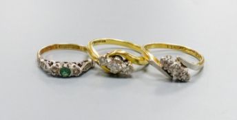 Two 18ct and three stone diamond set crossover rings, sizes K and N and an 18ct & plat, emerald and