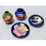 Two Moorcroft Hibiscus pattern vases and a similar dish together with a Moorcroft wisteria pattern