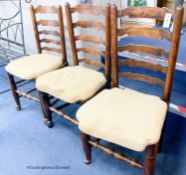 A harlequin set of eight ash rush seat ladder back dining chairs with squab seats