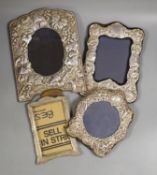 Four assorted modern silver mounted photograph frames including three with repousse decoration,