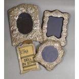 Four assorted modern silver mounted photograph frames including three with repousse decoration,