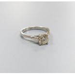 A modern platinum and single stone diamond ring, with trapeze cut diamond set shoulders, size N,