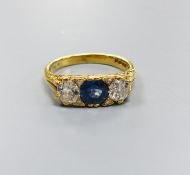 A 1970's Victorian style 18ct gold, single stone synthetic? sapphire and two stone diamond set