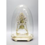 A 19th century brass skeleton clock on marble base. Associated glass dome, total height 44.5 cm