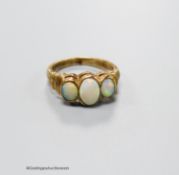 A 9ct gold and three stone white opal set half hoop ring, with ribbed shoulders, size K, gross 3.5