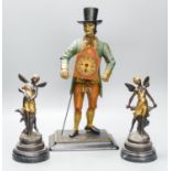 A painted cast iron figure all mantle timepiece and a pair of bronze figures of fairies, tallest 40