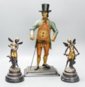 A painted cast iron figure all mantle timepiece and a pair of bronze figures of fairies, tallest 40