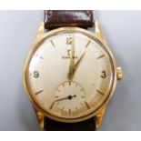 A gentleman's 1950's 9ct gold Omega manual wind wrist watch, movement c.266, on associated strap,