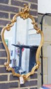 A reproduction Rococo style gilt wall mirror W 48, H 82 cms.