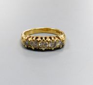 A five-stone diamond ring, 18ct yellow gold setting, claw-set with carved shoulders, size K, gross