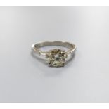 A modern platinum and single stone diamond ring, with trapeze cut diamond set shoulders, size O,