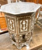 A Middle Eastern mother of pearl and bone inlaid octagonal topped coffee table, width 45cm, height